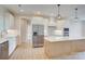 Open-concept kitchen featuring white cabinets, stainless steel appliances, a center island, and stylish pendant lights at 2355 Emanuel Church Rd, Rockwell, NC 28138