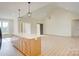 Open living area featuring high ceilings, wood floors, gourmet kitchen with center island, and pendant lights at 2355 Emanuel Church Rd, Rockwell, NC 28138