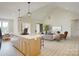 Bright open-concept living room with vaulted ceilings and a modern island with bar stool seating at 2355 Emanuel Church Rd, Rockwell, NC 28138