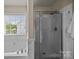 Modern bathroom features a soaking tub, glass shower, and tiled walls at 252 Legend Dr, Rock Hill, SC 29732