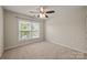 Bright bedroom featuring a ceiling fan, neutral walls, carpet flooring, and a window with natural light at 252 Legend Dr, Rock Hill, SC 29732