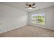 Bedroom features carpet, a ceiling fan, and natural light from the large window at 252 Legend Dr, Rock Hill, SC 29732