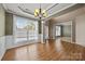 Bright dining room featuring hardwood floors, a large window, and elegant chandelier lighting at 252 Legend Dr, Rock Hill, SC 29732