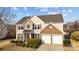 Beautiful two-story home with a well-manicured lawn, brick accents, and a two-car garage at 252 Legend Dr, Rock Hill, SC 29732