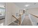 Bright upstairs hallway with carpet floors, stairs, and white railing with access to multiple rooms at 252 Legend Dr, Rock Hill, SC 29732