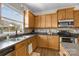 Kitchen features wood cabinets, stainless steel appliances, and natural light from a window at 252 Legend Dr, Rock Hill, SC 29732