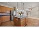 Bright kitchen featuring wood cabinets, stainless steel appliances, a kitchen island, and hardwood floors at 252 Legend Dr, Rock Hill, SC 29732