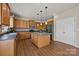 Well-lit kitchen with wood cabinets, stainless steel appliances, and an island with a gray countertop and pendant lighting at 252 Legend Dr, Rock Hill, SC 29732