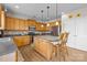 Kitchen with wood cabinets, stainless steel appliances, center island with seating, and tile backsplash at 252 Legend Dr, Rock Hill, SC 29732