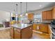 Bright kitchen island open to dining area features stainless appliances and wood floors at 252 Legend Dr, Rock Hill, SC 29732
