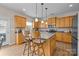 Kitchen with wood cabinets, stainless steel appliances, center island with seating, and wood floors at 252 Legend Dr, Rock Hill, SC 29732