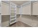 Well-organized walk-in closet with shelving, hanging rods, and carpeted floor at 252 Legend Dr, Rock Hill, SC 29732