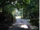 Long private driveway lined with mature trees and landscaping, offering a sense of seclusion at 2818 Cherry Ln, Denver, NC 28037