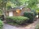 Exterior view of a cozy brick home surrounded by lush, mature landscaping at 2818 Cherry Ln, Denver, NC 28037