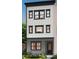 Modern three-story home boasts vertical siding, dark window frames, and a welcoming front entrance at 305 Old Town Village Rd, Waxhaw, NC 28173