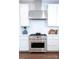 Modern kitchen featuring stainless steel range, white subway tile backsplash, and sleek cabinetry at 305 Old Town Village Rd, Waxhaw, NC 28173