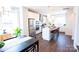 Bright kitchen features an island with seating, modern appliances, and seamless flow to the dining area at 305 Old Town Village Rd, Waxhaw, NC 28173