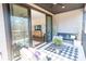 Cozy outdoor patio with a fireplace, seating, and a view into the living room at 305 Old Town Village Rd, Waxhaw, NC 28173