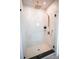 Glass shower with marble-style tile, modern fixtures, and niche for toiletries at 305 Old Town Village Rd, Waxhaw, NC 28173