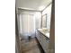 Bathroom featuring double sinks, wood-look countertops, lots of lighting, and vinyl plank flooring at 404 B And S Ln, Hickory, NC 28601