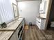 Bathroom with wood-look floor and vanity and storage shelves at 404 B And S Ln, Hickory, NC 28601