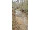 Serene creek flowing through the wooded area, providing a peaceful atmosphere at 404 B And S Ln, Hickory, NC 28601