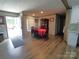 Dining room with easy access to the front door features a table set for eight and vinyl plank flooring at 404 B And S Ln, Hickory, NC 28601