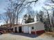 Detached three-car garage, painted tan with red trim, providing plenty of storage at 404 B And S Ln, Hickory, NC 28601