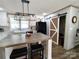 Charming kitchen with a spacious island, modern light fixture, barn door, and black appliances at 404 B And S Ln, Hickory, NC 28601