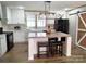 Modern kitchen featuring white cabinets, an island with seating, and stainless steel appliances at 404 B And S Ln, Hickory, NC 28601