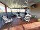 This cozy covered patio has a grill, table, chairs, and fan, perfect for outdoor gatherings at 404 B And S Ln, Hickory, NC 28601