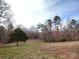 Large, grassy property with mature trees and a peaceful, natural setting at 404 B And S Ln, Hickory, NC 28601