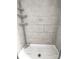 Standing shower stall with mounted caddy and white stone-style tile at 404 B And S Ln, Hickory, NC 28601