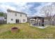 Backyard with gazebo, fire pit, grill, furniture set, and house view at 4213 Devonbridge Ln, Charlotte, NC 28269