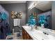 Well-lit bathroom featuring a double sink vanity, butterfly patterned shower curtain, and patterned floor, creating character at 4213 Devonbridge Ln, Charlotte, NC 28269