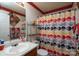Bathroom featuring a single sink, a mirror, and a colorful shower curtain at 4213 Devonbridge Ln, Charlotte, NC 28269