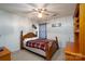 Cozy bedroom featuring a traditional wooden bed frame, ceiling fan, and modern accents, creating a comfortable space at 4213 Devonbridge Ln, Charlotte, NC 28269