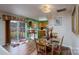 A dining room and kitchen combo has stylish chairs, an elegant chandelier, and a sliding glass door at 4213 Devonbridge Ln, Charlotte, NC 28269