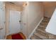 Inviting foyer with carpeted stairs, white doors, and wood floors creates a warm and welcoming entrance at 4213 Devonbridge Ln, Charlotte, NC 28269