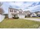 Charming two-story home with a well-maintained lawn, two-car garage, and an inviting front porch at 4213 Devonbridge Ln, Charlotte, NC 28269