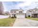 Charming two-story home with a well-maintained lawn and a two-car garage and red shutters at 4213 Devonbridge Ln, Charlotte, NC 28269