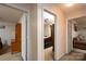 Hallway featuring doorways to a bedroom, office, and living room, providing easy access to living spaces at 4213 Devonbridge Ln, Charlotte, NC 28269