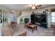 Cozy living room features a fireplace, plush sofas, and a large window with lots of natural light at 4213 Devonbridge Ln, Charlotte, NC 28269