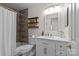 Modern bathroom featuring a shower-tub combo, with wood-look tile, floating shelves, and vanity at 4741 Lauren Glen Nw St, Concord, NC 28027