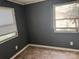 This bedroom features vinyl flooring, gray walls and natural light from the two bright windows at 504 Elizabeth Dr, Gastonia, NC 28052