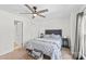 Relaxing bedroom offers neutral tones, a ceiling fan, and ample natural light at 525 N Graham St # 2F, Charlotte, NC 28202