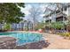 Relaxing community pool surrounded by lush greenery, brick walkways and well-maintained apartment buildings at 525 N Graham St # 2F, Charlotte, NC 28202