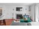 Cozy living room with a fireplace, mounted TV, and built-in shelving at 525 N Graham St # 2F, Charlotte, NC 28202