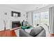 The open living room features a fireplace, mounted TV, and access to the patio at 525 N Graham St # 2F, Charlotte, NC 28202