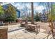 Outdoor patio with tables, chairs, and barbecue grills at 525 N Graham St # 2F, Charlotte, NC 28202